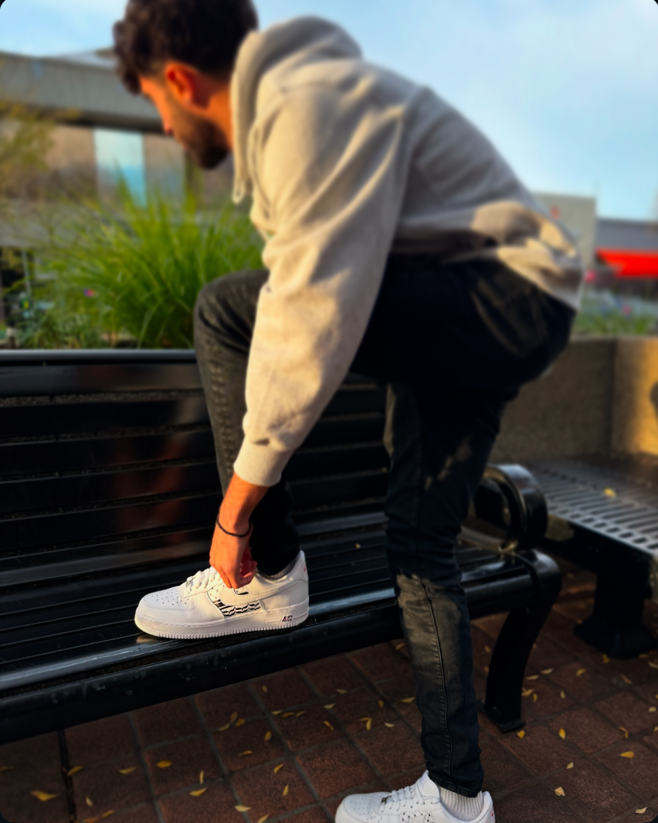 Artist wearing custom Palestinian flag Air Force 1s, showcasing the craftsmanship and street style